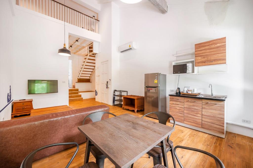 a kitchen and dining room with a table and chairs at Kokotel Khao Lak Lighthouse in Khao Lak