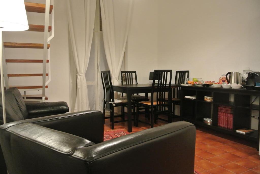 salon z kanapą, stołem i krzesłami w obiekcie Studio Errepì Loreto w Mediolanie