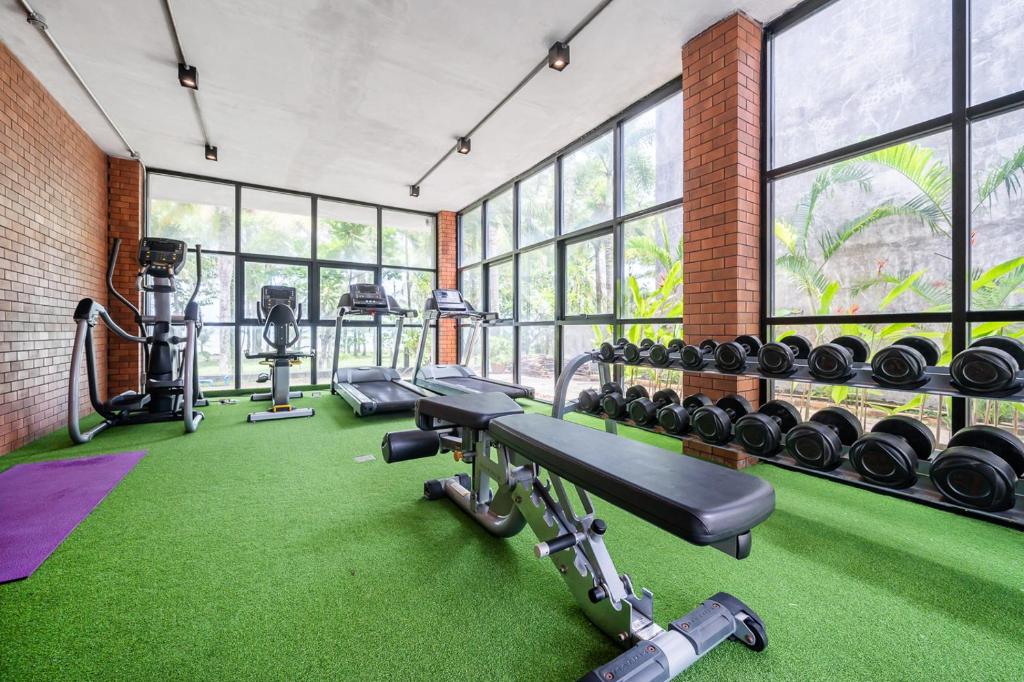 a gym with a row of treadmills and weights at Kokotel Khao Lak Lighthouse in Khao Lak