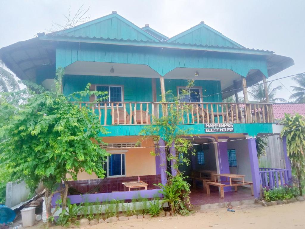a house with a balcony on top of it at Happiness Guesthouse in Koh Rong Sanloem