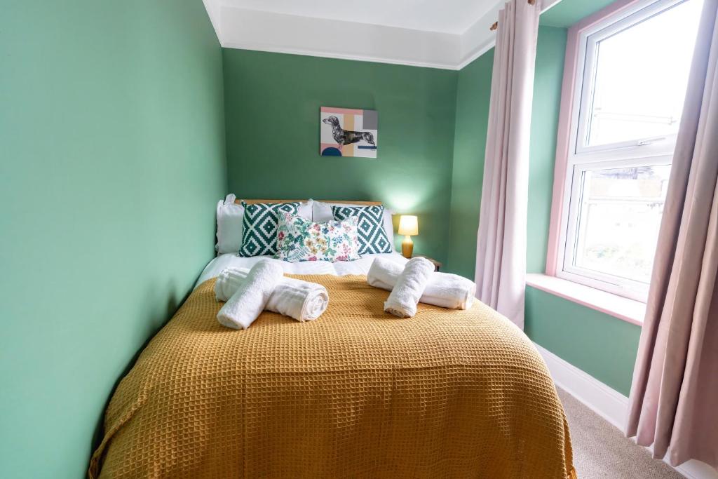 a bedroom with a bed with towels on it at Daffodil House in Cockermouth