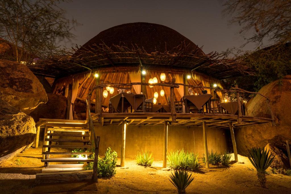a building with chairs and lights on it at Camp Kipwe in Twyfelfontein