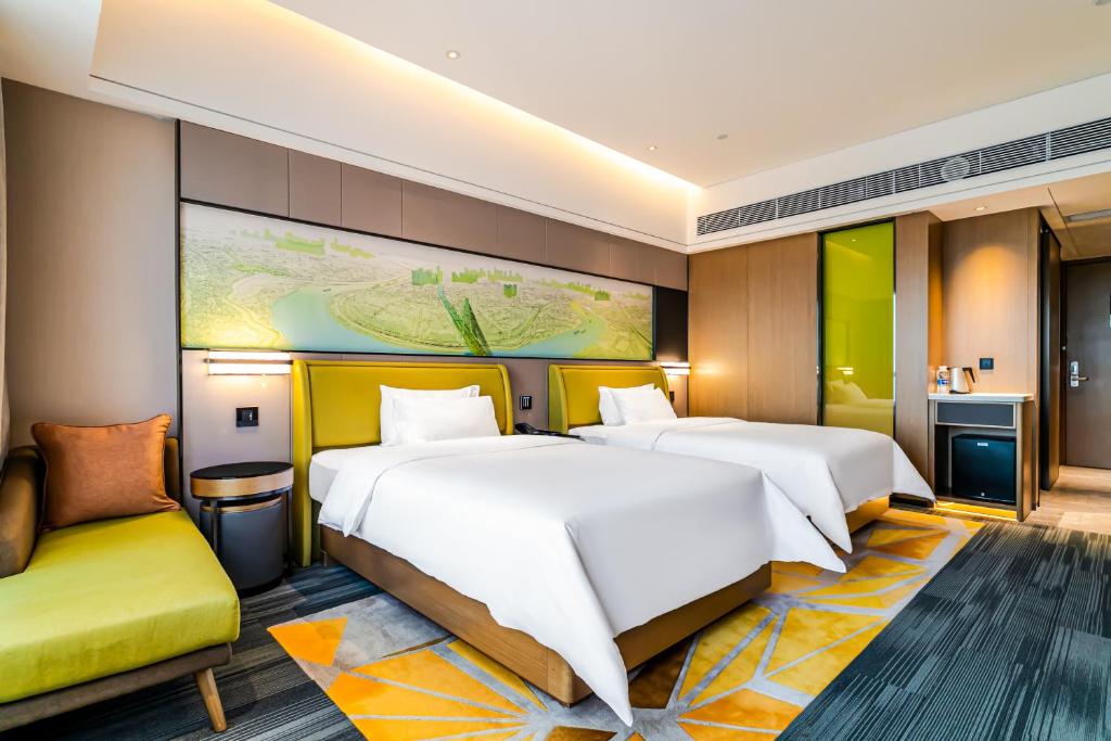 Postel nebo postele na pokoji v ubytování 佛山敏卓酒店Mentor Hotel