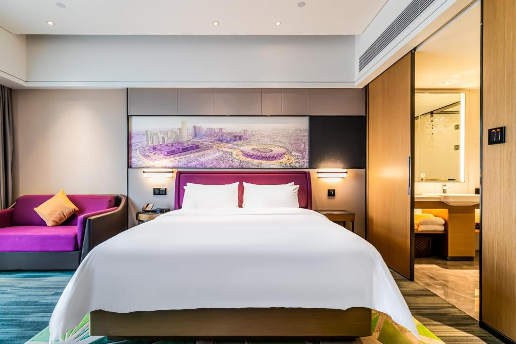 Postel nebo postele na pokoji v ubytování 佛山敏卓酒店Mentor Hotel