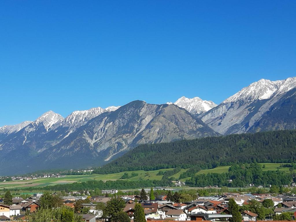 a small town in front of a mountain range at TOP Mountain View in Volders