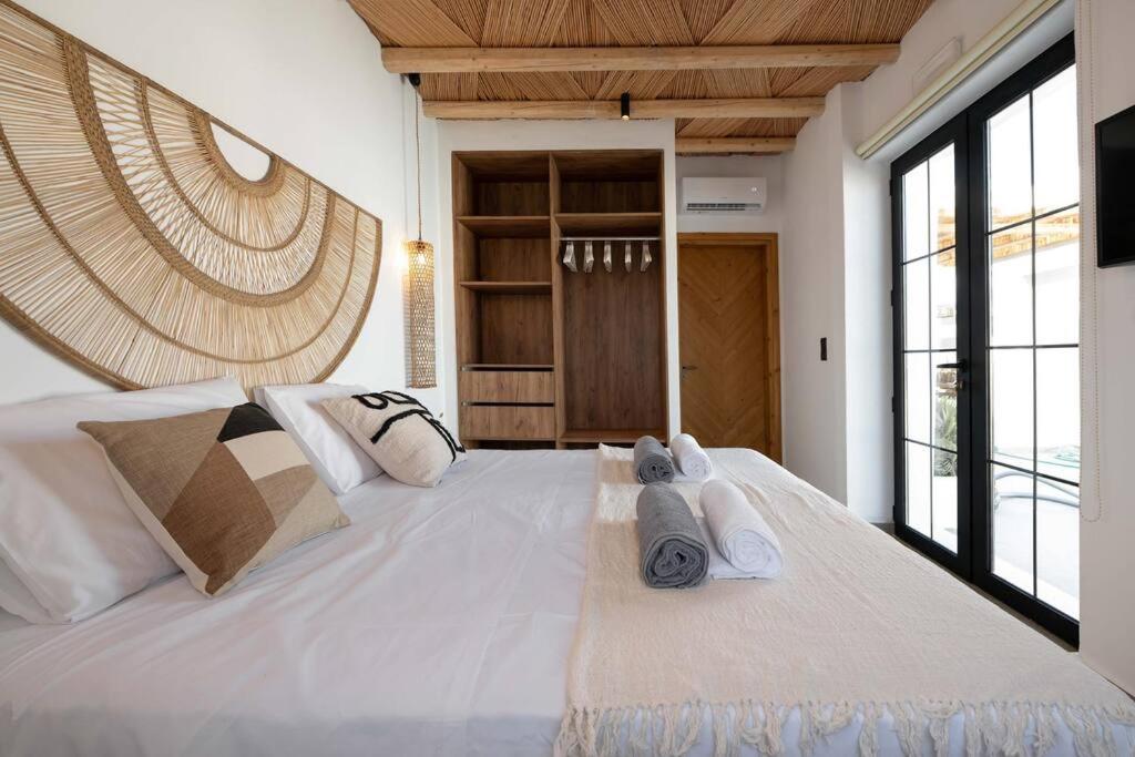 A bed or beds in a room at CasaCarma II, private pool, boho design, tradition