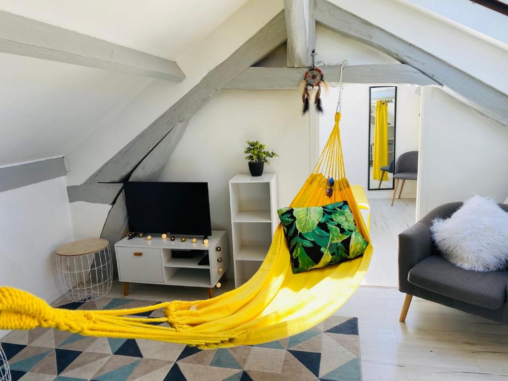 ein Wohnzimmer mit einer gelben Hängematte. in der Unterkunft Appartement douillet 1 chambre - centre ville in Argenteuil