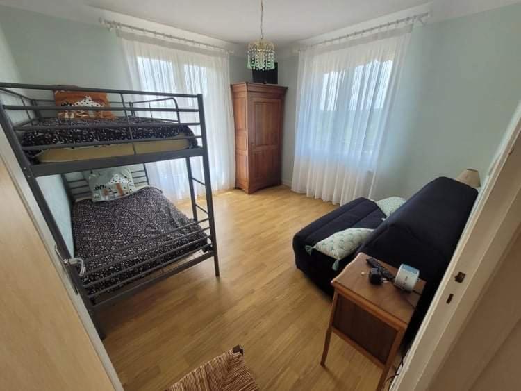 ein Wohnzimmer mit einem Etagenbett und einem Sofa in der Unterkunft Claire fontaine in Beaumont-du-Périgord