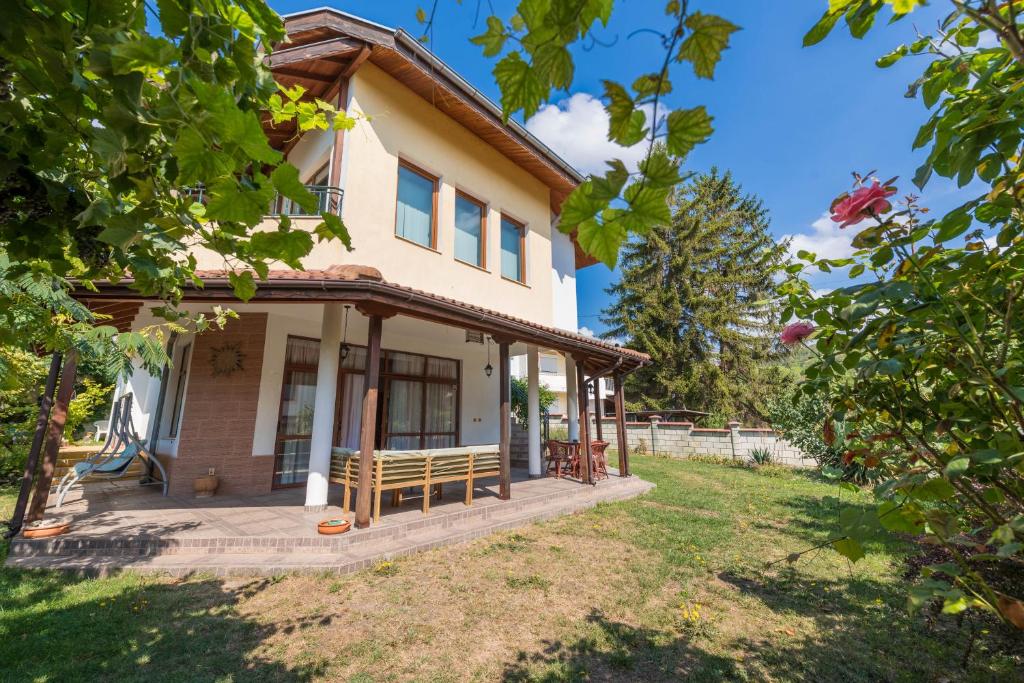 a house with a large yard in front of it at Villa ADORA in Balchik
