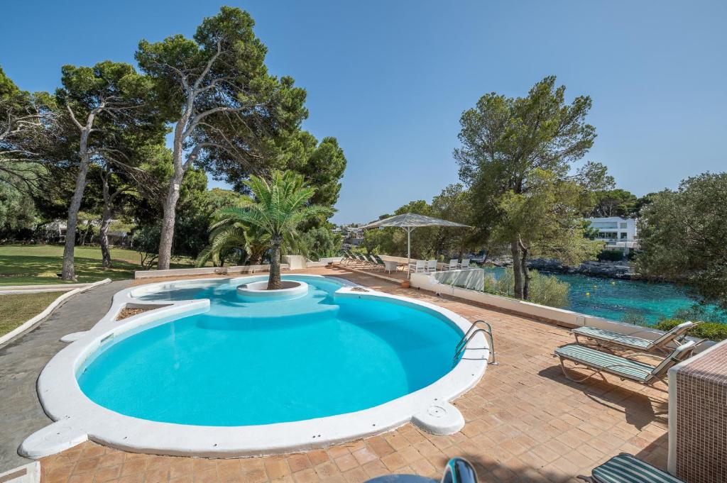 a pool with a resort style swimming pool at Villa Claramunda in Cala D'or