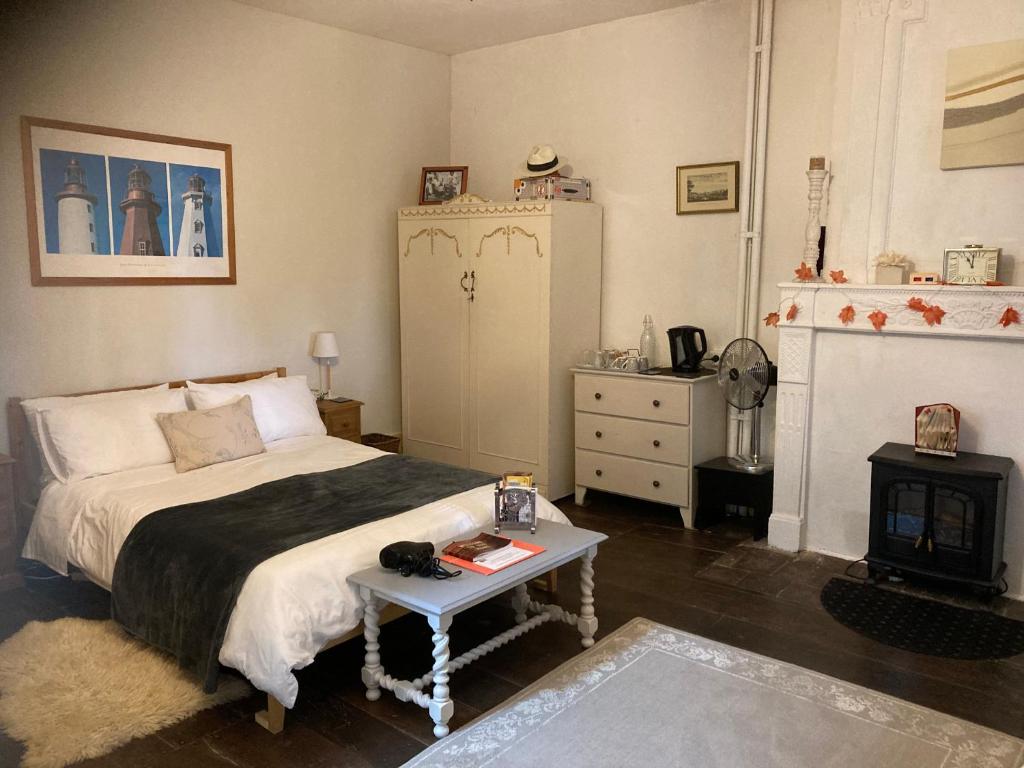 a bedroom with a bed and a table in it at 7 Dagnaud De la Tude our family farmhouse style home with en-suite in Montboyer