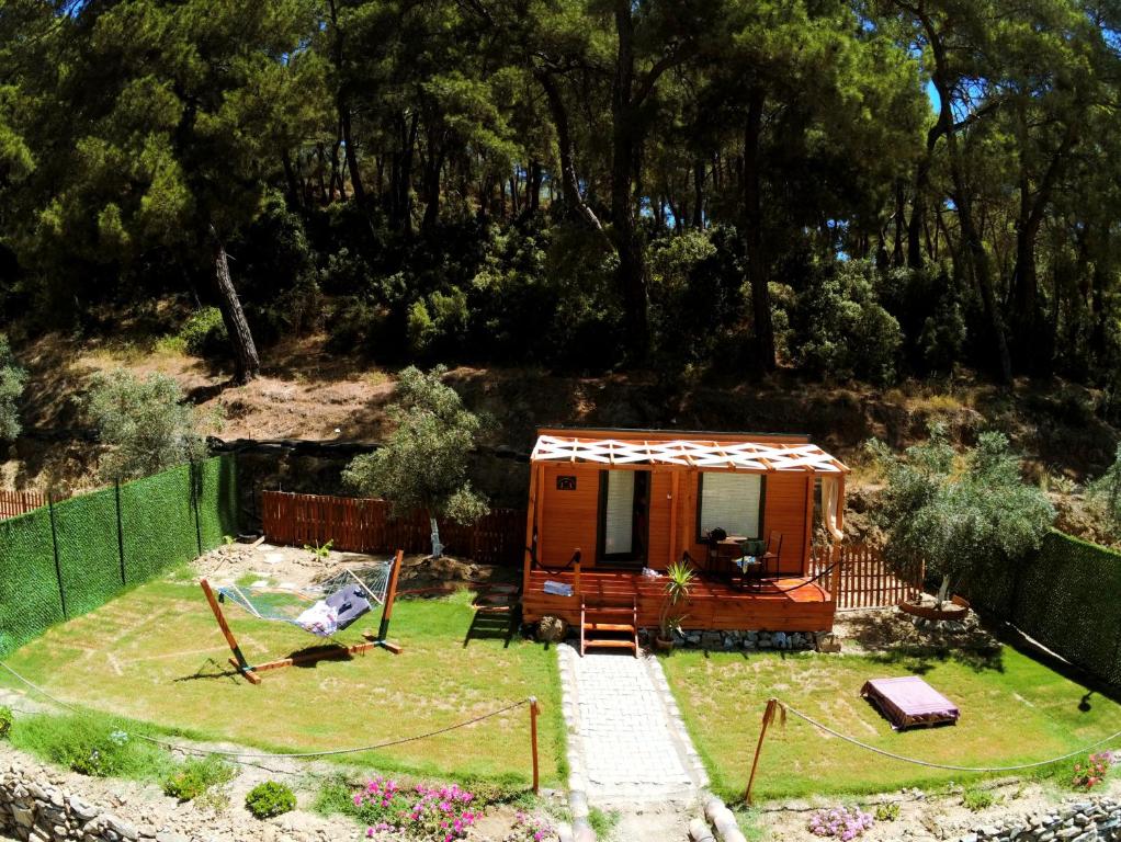 a tiny house in a yard with a fence at Tiny Mini House in Dalaman