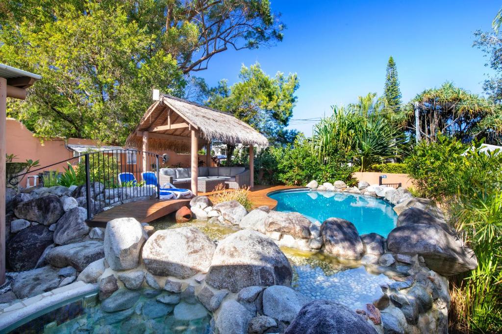a backyard with a pool and a gazebo at L'Auberge Noosa in Noosa Heads