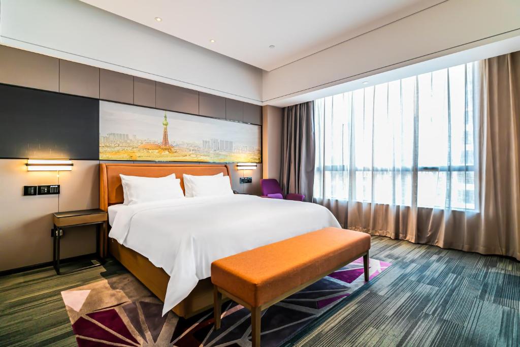 Postel nebo postele na pokoji v ubytování 佛山敏卓酒店Mentor Hotel
