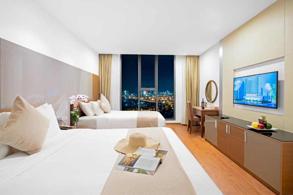 Postel nebo postele na pokoji v ubytování Alan Sea Hotel Danang