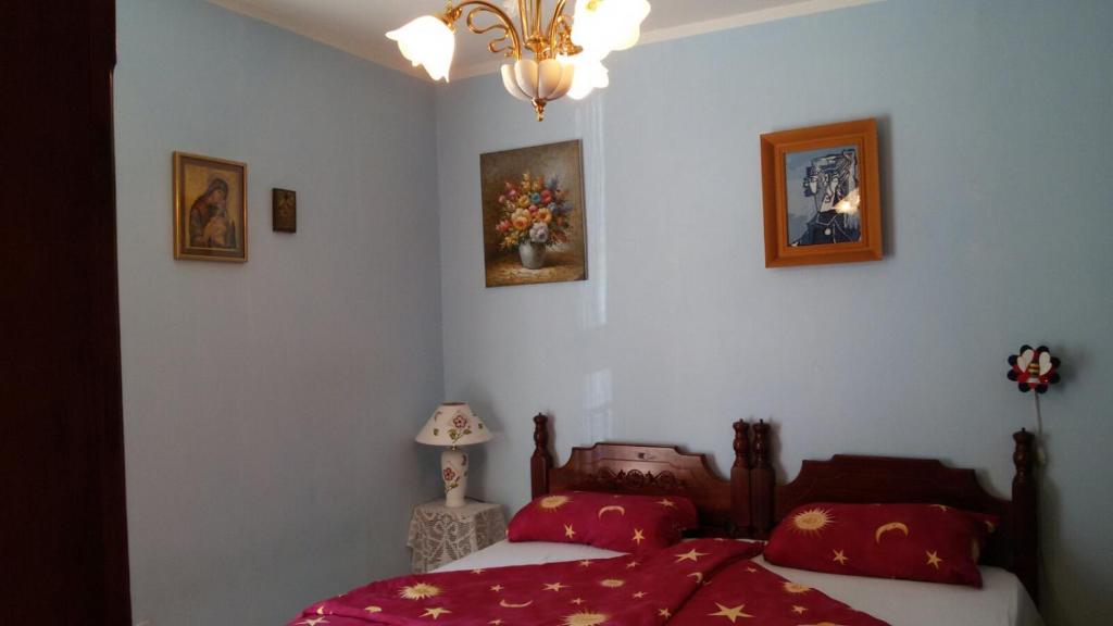 a bedroom with two beds and two pictures on the wall at Oriental Apartment in Plužine