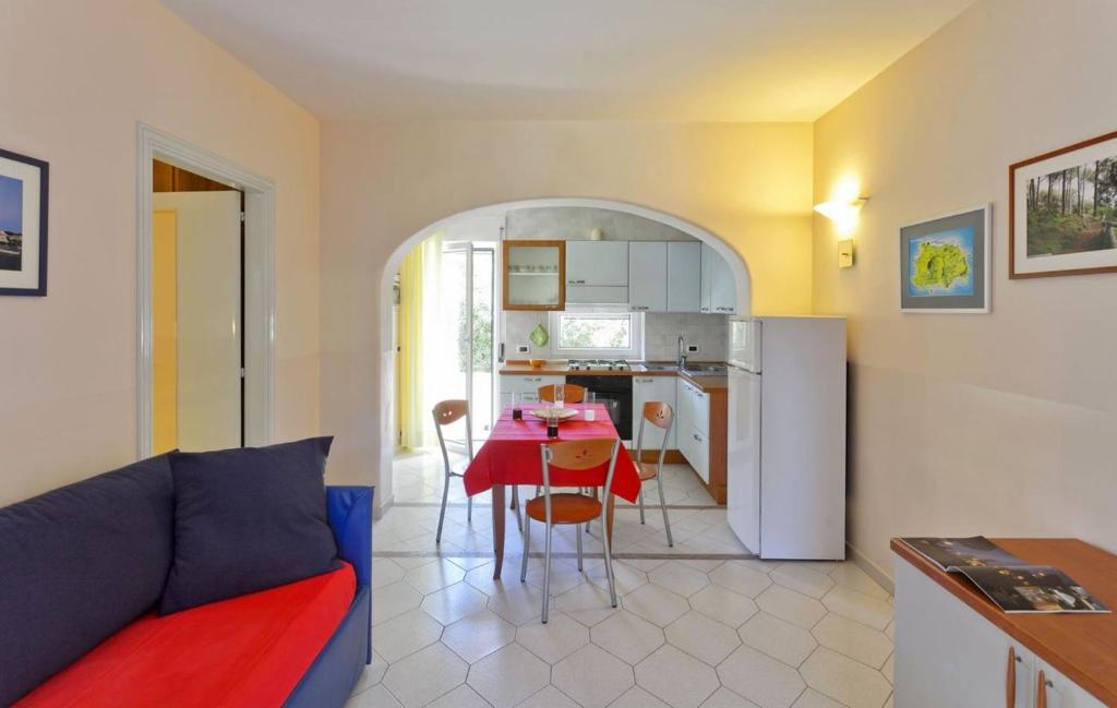 a living room and kitchen with a table and a couch at Casa Vacanze Parco Del Generale in Ischia
