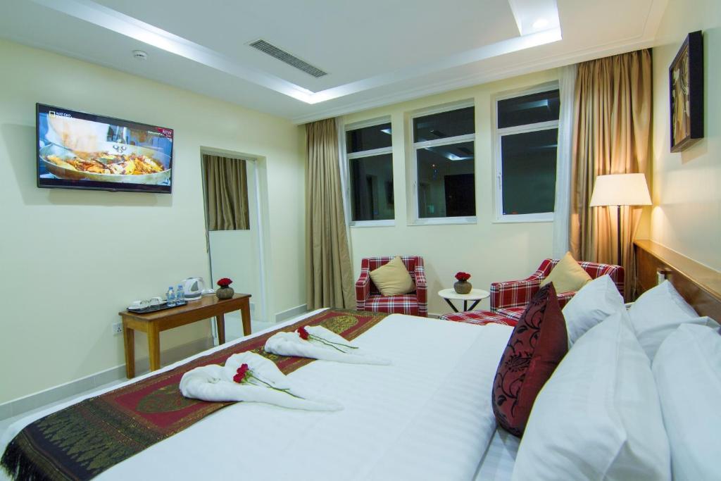 Postel nebo postele na pokoji v ubytování Rose Emerald Hotel
