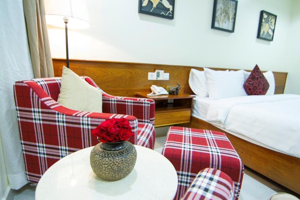 Postel nebo postele na pokoji v ubytování Rose Emerald Hotel