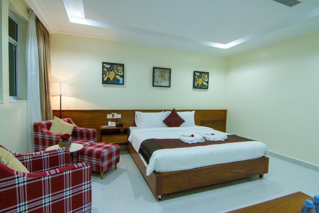 Postel nebo postele na pokoji v ubytování Rose Emerald Hotel