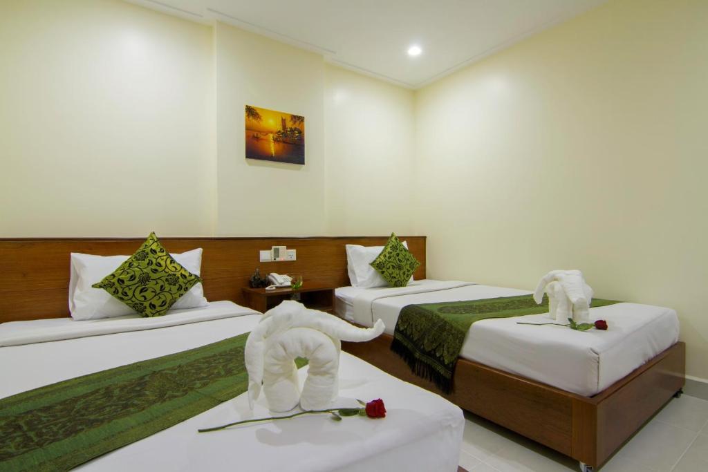 Postel nebo postele na pokoji v ubytování Rose Emerald Hotel