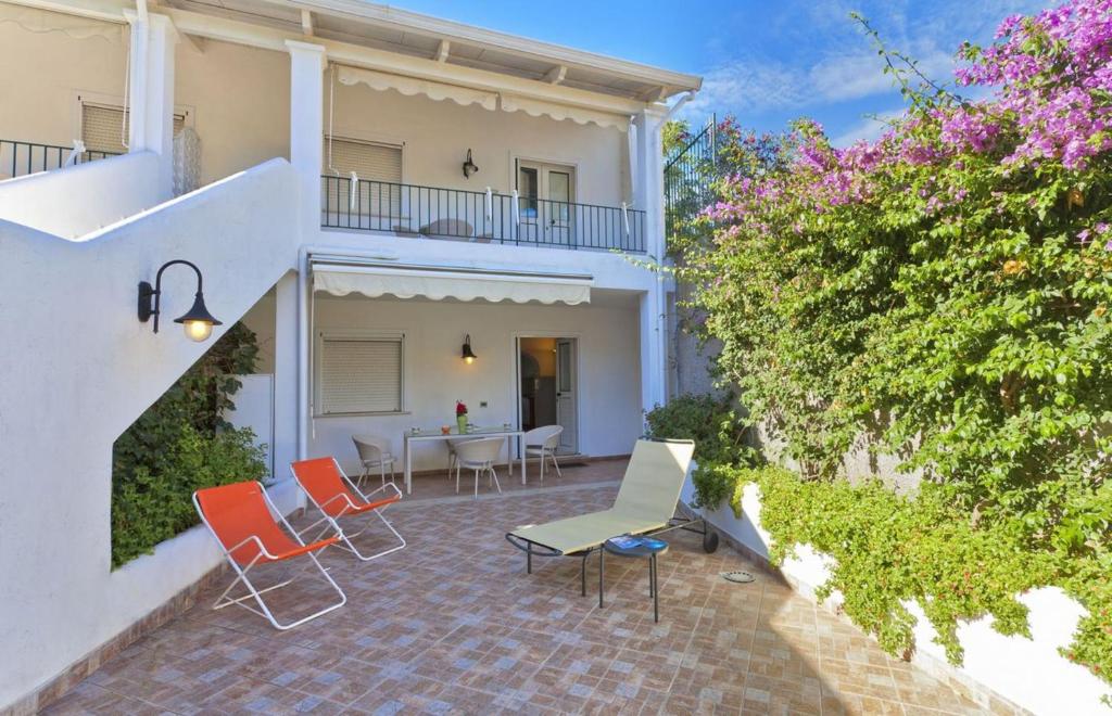 a patio with chairs and a table in front of a building at Casa Vacanze Parco Del Generale in Ischia