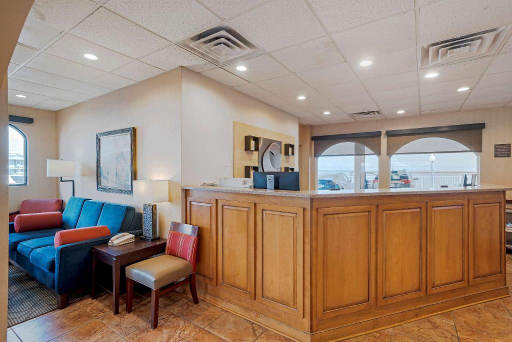 a waiting room with a blue couch and a table at Comfort Inn Ocean City Boardwalk in Ocean City