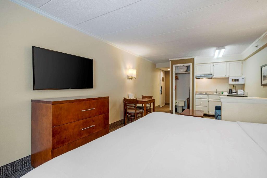 a hotel room with a bed and a flat screen tv at Comfort Inn Ocean City Boardwalk in Ocean City