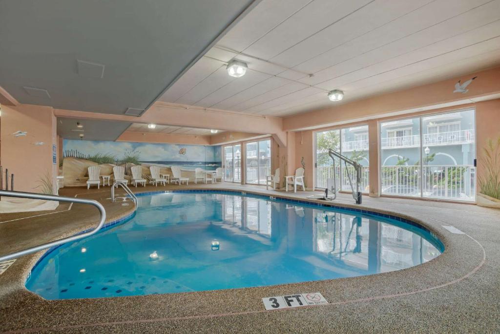 a swimming pool in a hotel room with a large window at Comfort Inn Ocean City Boardwalk in Ocean City