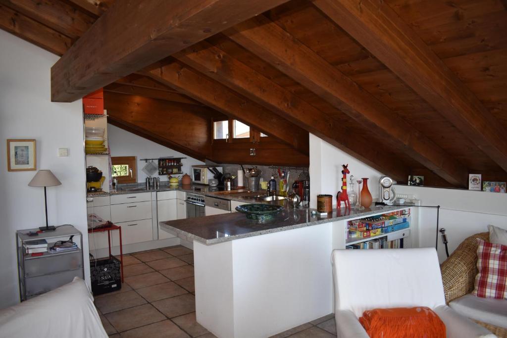 a kitchen with white cabinets and a wooden ceiling at Beal Lia Haus C 474 Bh Whg 8 in Lenz