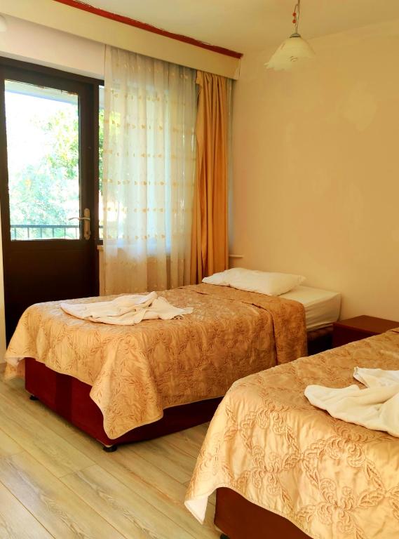 Postel nebo postele na pokoji v ubytování Artemis Yörük Hotel - Pamukkale Denizli