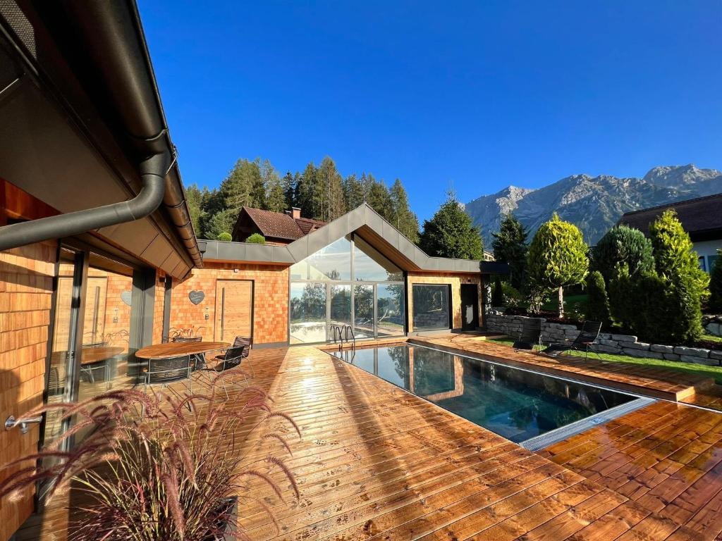a house with a swimming pool in a yard at Chalet Annelies in Ramsau am Dachstein