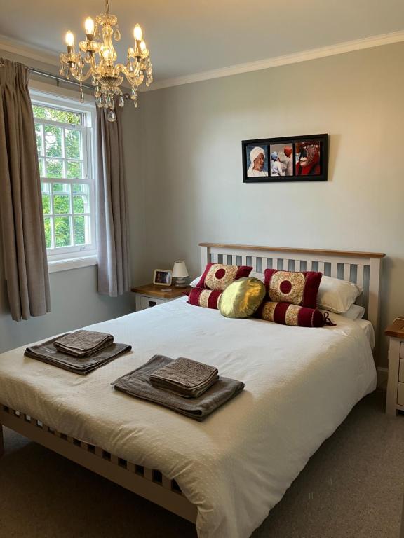a bedroom with a large bed with towels on it at Little Silver in Great Torrington