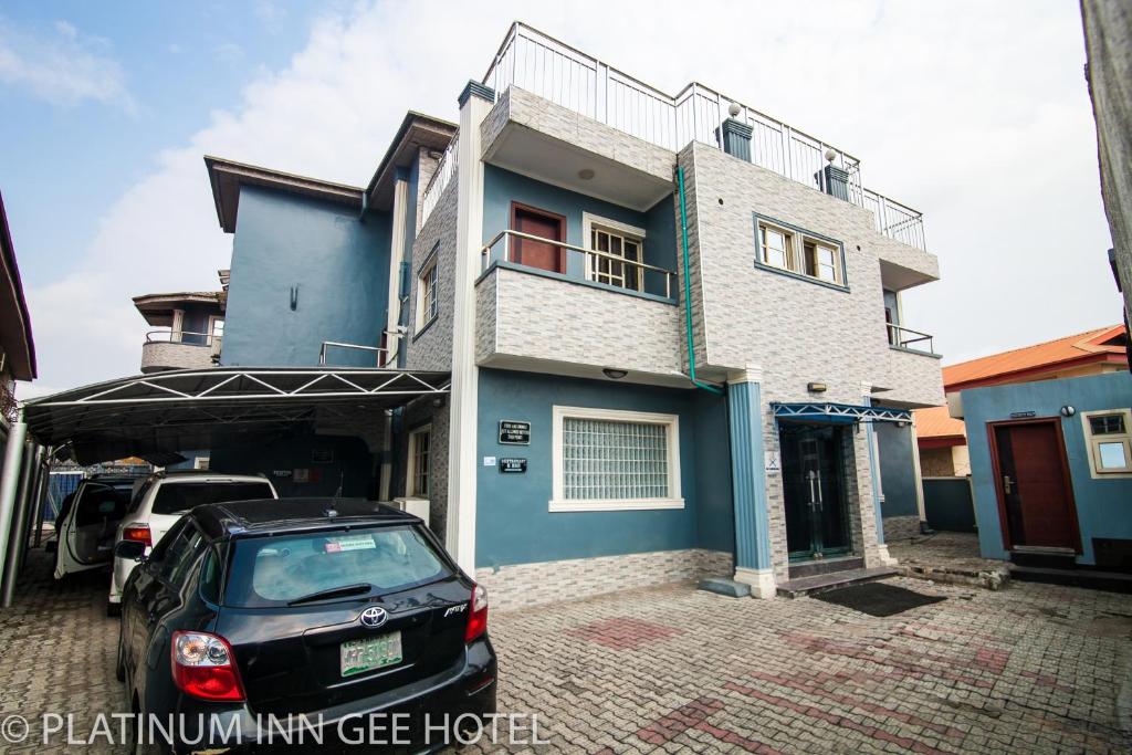 a car parked in front of a house at Platinum Inn Gee Hotel in Suru Lere