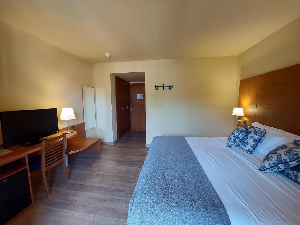 Posteľ alebo postele v izbe v ubytovaní Hotel Saurat