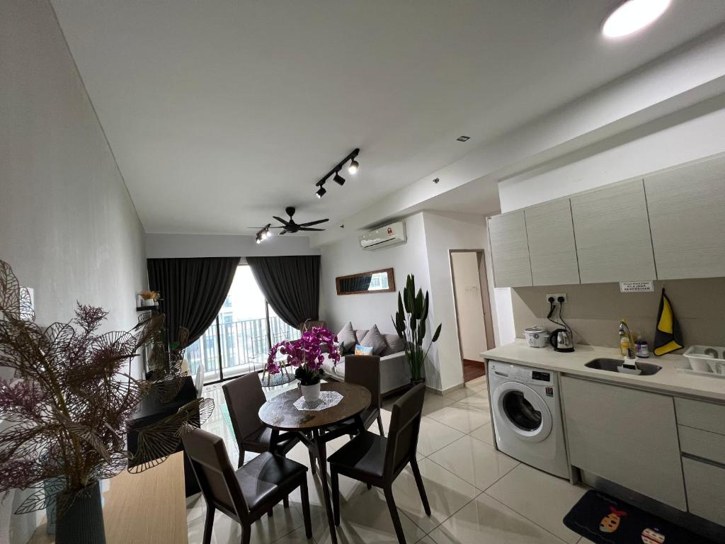 a kitchen and dining room with a table and chairs at D'Gunduls Homestay Family Suite 2R 2B by DGH I-CITY in Shah Alam