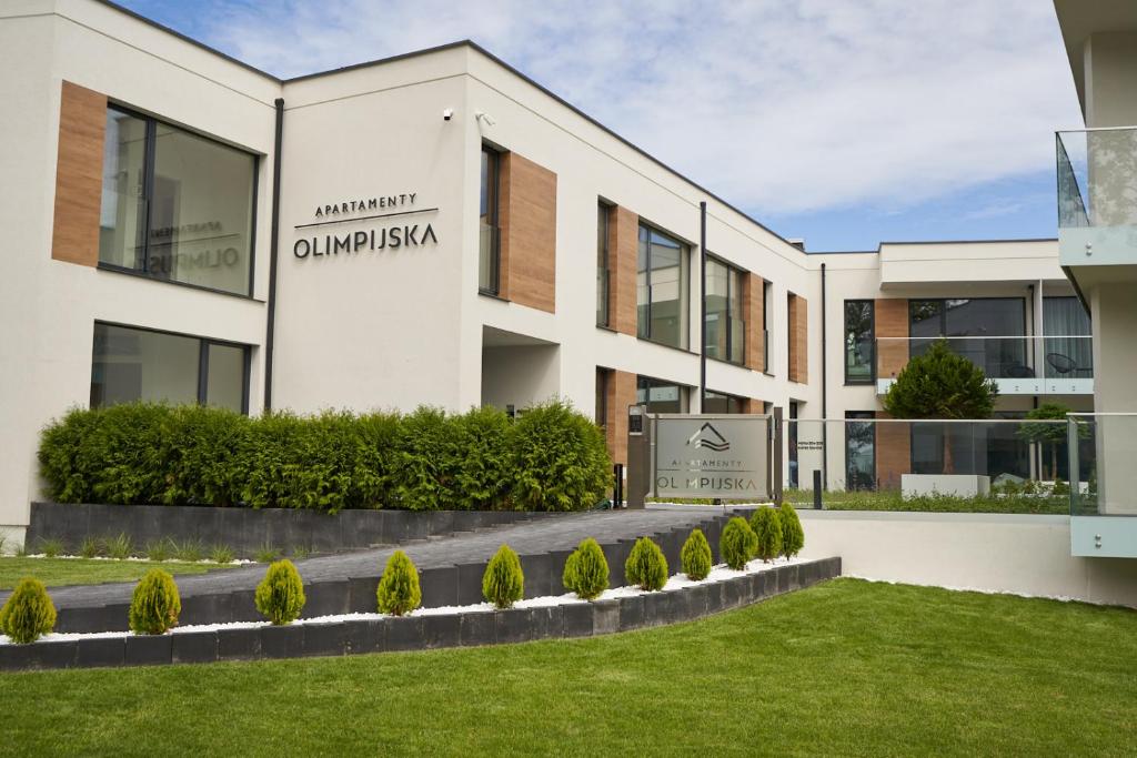 a building with a sign that reads ontario embassy at Apartamenty Olimpijska by RENT4YOU in Olsztyn