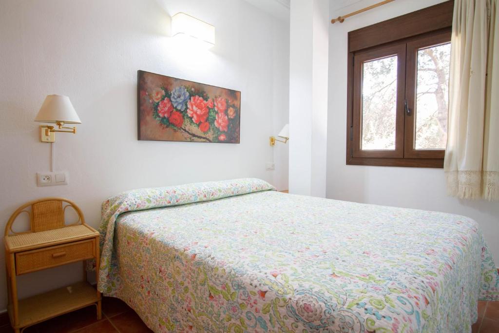 Posteľ alebo postele v izbe v ubytovaní Apartamentos Turisticos Trajano