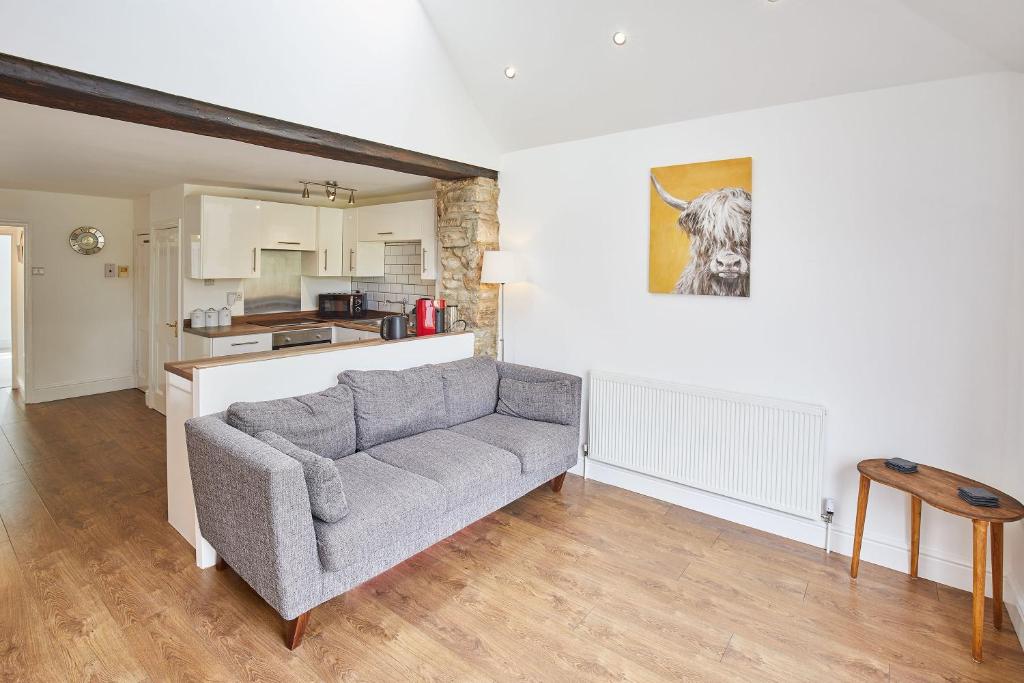 a living room with a couch and a kitchen at Host & Stay - The Duck Pond in Durham