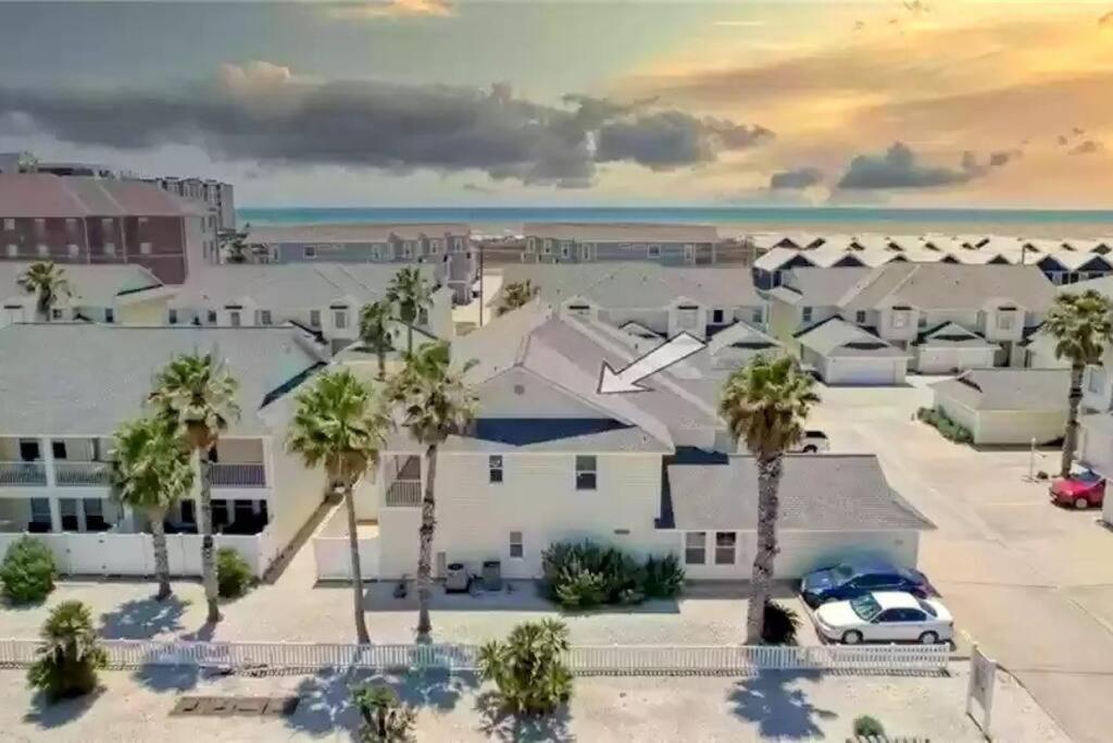 an aerial view of a resort with palm trees and the ocean at Spacious Home, Short Walk to Beach, Heated Pool! in Corpus Christi