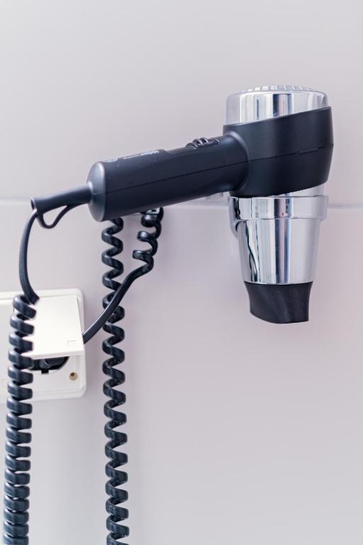 a blow dryer plugged into a wall at Citybox Oslo in Oslo