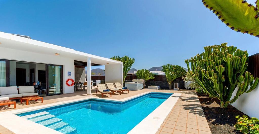 a villa with a swimming pool and a house at Jacks Place Villa PlayaBlanca Pool Spa in Playa Blanca