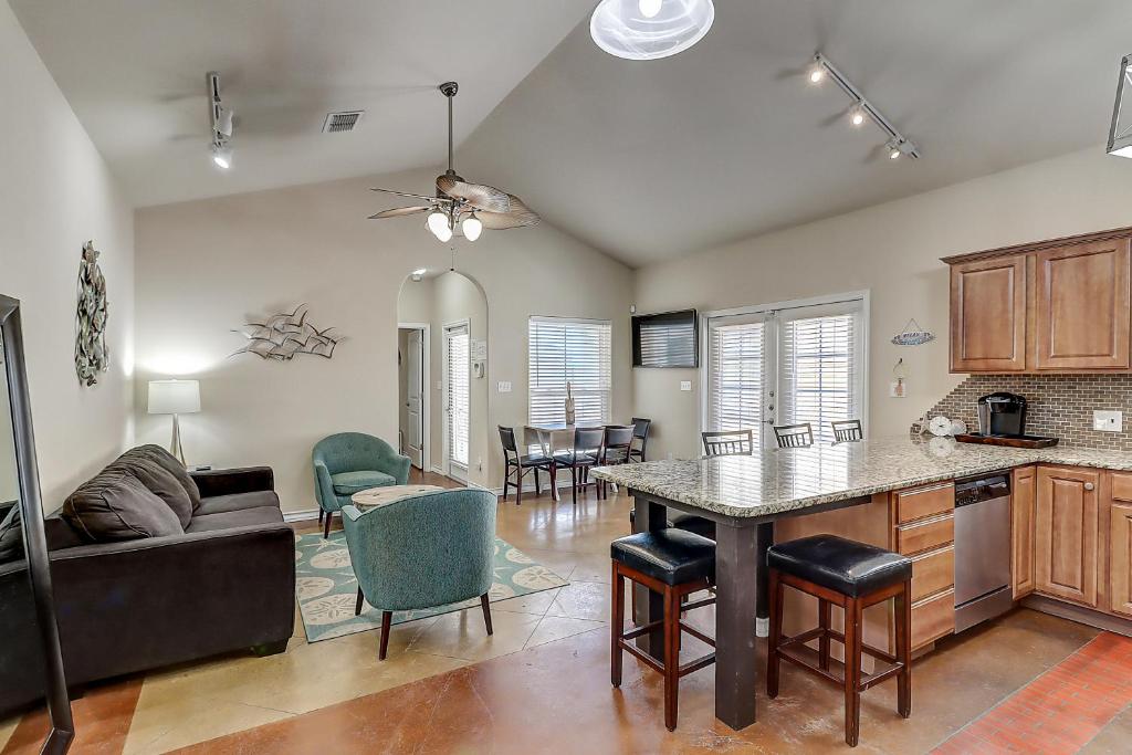 a kitchen and living room with a table and chairs at Marquesas #310 in Padre Island