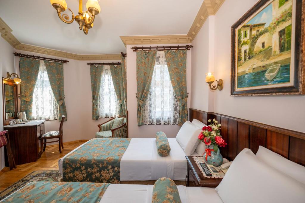 Postel nebo postele na pokoji v ubytování Osmanhan Hotel