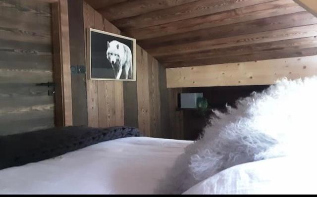 Voodi või voodid majutusasutuse Chalet avec jacuzzi - 150 m des remontées toas