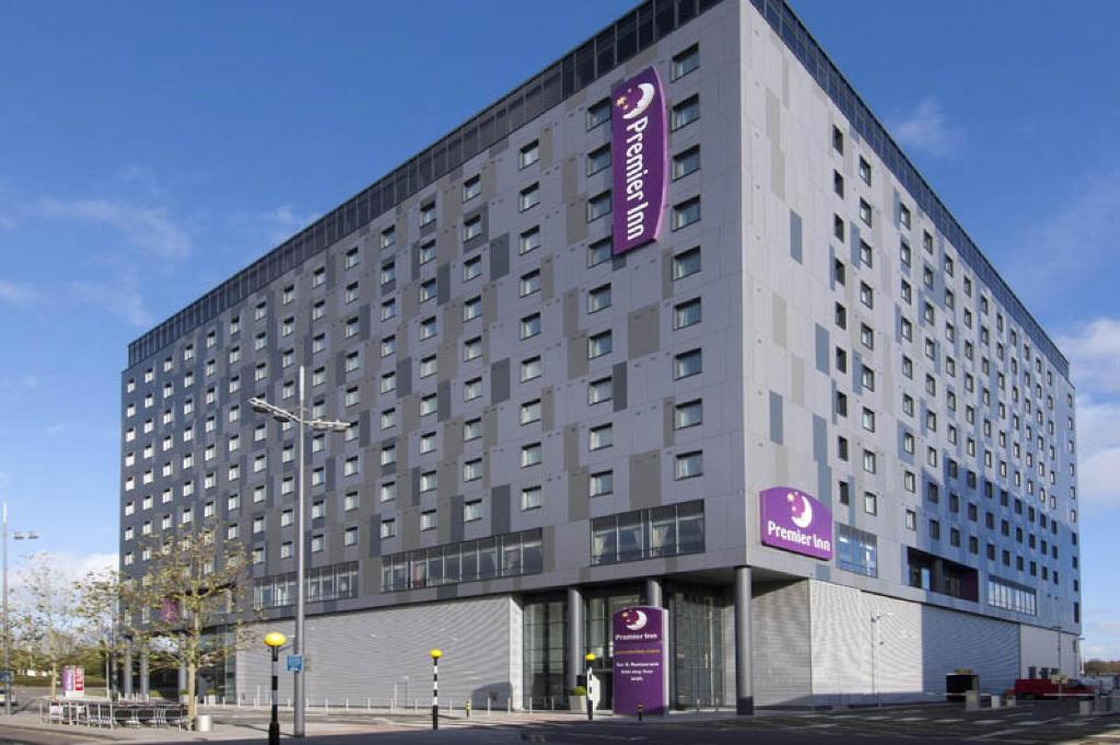 a large building with a clock on the side of it at Premier Inn London Gatwick Airport - North Terminal in Crawley