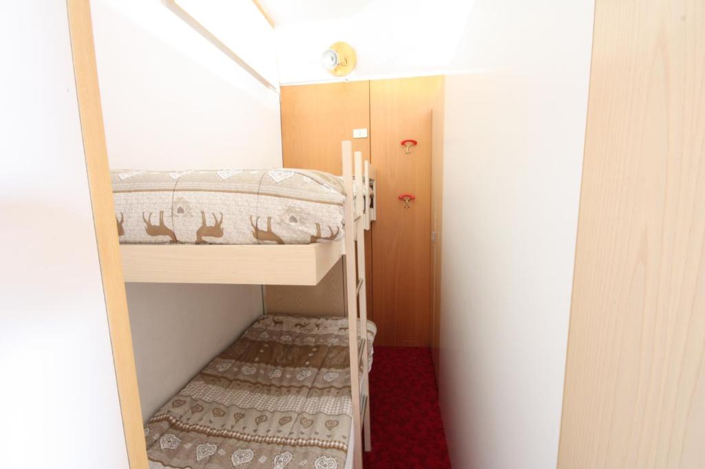 a small room with a bunk bed and a hallway at Marilleva 1400 Appartamenti Montana in Marilleva