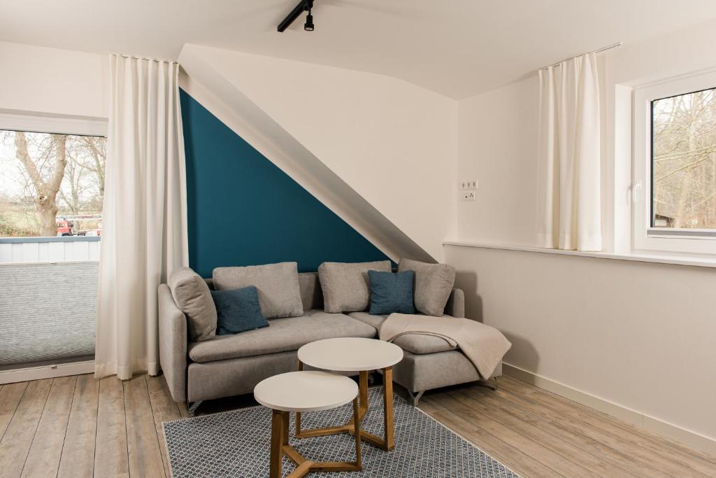 a living room with a couch and a table at Strandappartements Steinberghaff "Sonderborg" mit Parkblick in Steinberg