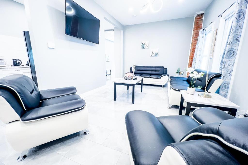 a waiting room with blue chairs and tables at The Griffon House in Niagara Falls