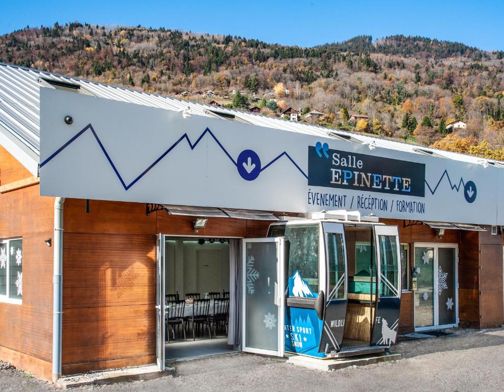 a building with a sign that reads sell furniture at L'Epinette - Gîte de groupe et salle de réception in Allevard